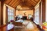 Sitting room featuring high vaulted ceiling, a wood ceiling with exposed beams, arched walkways, and a chandelier