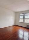 Empty room with radiator, hardwood / wood-style flooring, and baseboards