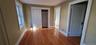 2nd Floor Front Building LR with wood flooring and a closet