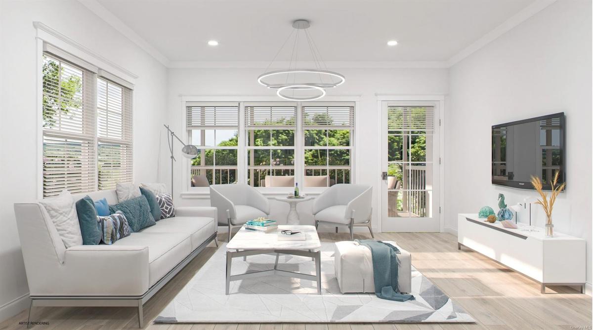 Living room with ornamental molding, recessed lighting, a notable chandelier, and light wood finished floors