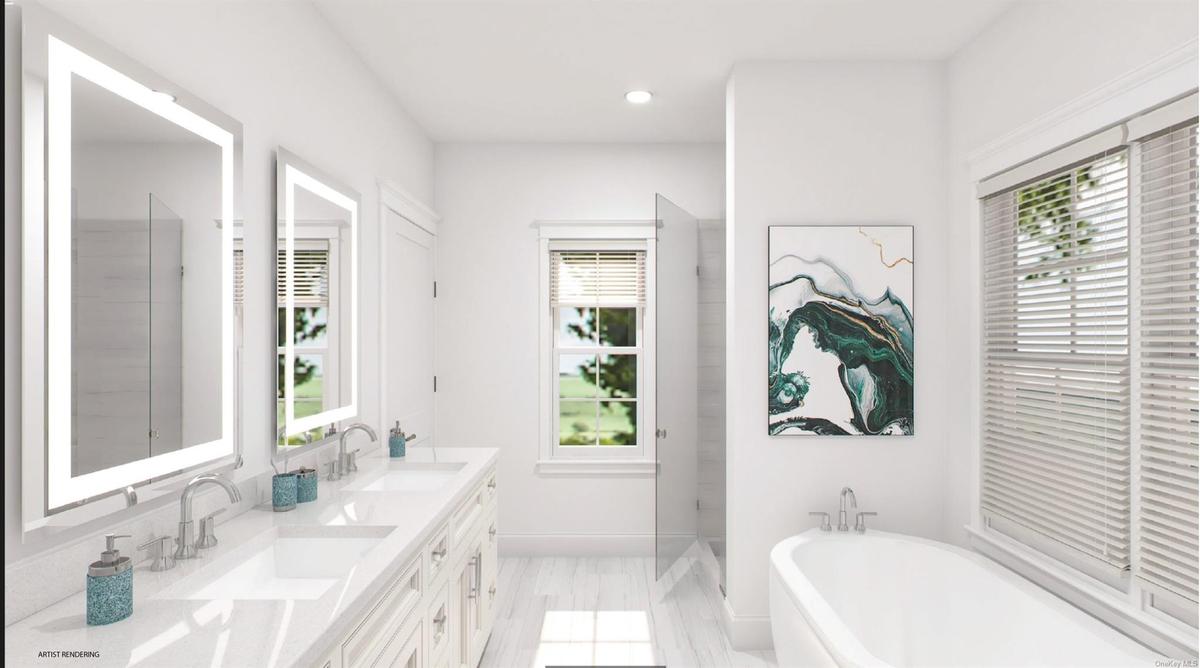 Full bath with double vanity, a soaking tub, a sink, and recessed lighting