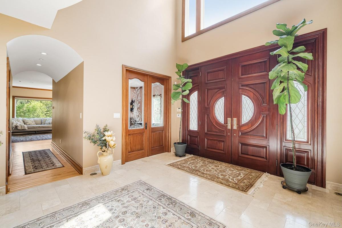 Foyer featuring arched walkways and high vaulted ceiling