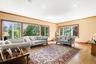 Living room featuring light wood-style floors, crown molding, and recessed lighting