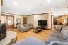 Living area featuring light wood-style flooring, recessed lighting, and crown molding