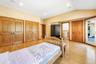 Bedroom with light wood-style floors, multiple closets, lofted ceiling, recessed lighting, and connected bathroom