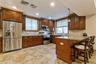 Kitchen with appliances with stainless steel finishes, a peninsula, decorative backsplash, a kitchen breakfast bar, and recessed lighting