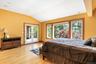 Bedroom with vaulted ceiling, access to exterior, light wood finished floors, and french doors