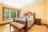 Bedroom featuring vaulted ceiling and light wood-type flooring
