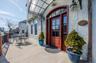 Main Entrance to home featuring awning, Large front deck, fencing, and stucco siding