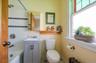 Main floor Office/Bedroom Bathroom featuring a wealth of natural light and shower/tub combination