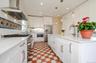 Large, bright Kitchen featuring stainless steel pro line appliances with stainless steel finishes, tile floors