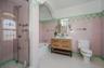 Updated Ensuite Primary Full bath featuring a separate tub and stall shower, and tile walls