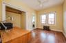 Main floor Office/Bedroom w wood flooring and ceiling fan