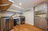Laundry room featuring a sink, washer and dryer, and access to utility room.