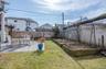 View of yard/gardens featuring patios, raised gardening beds, a fenced backyard, and access to lower, garden level/basement