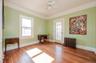 Bright bedroom with hardwood floors and  terrace access