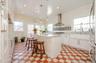 Large new eat in Kitchen with an island, quartz countertops, pro line appliances, tile floors, and white cabinetry