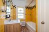 Another updated 2nd Floor Hall Bathroom featuring tile walls, and shower/tub combination