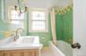 Updated 2nd floor Hall Bathroom featuring shower/bath combo, tile patterned floors and new vanity