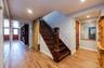 Stairway to Lower/Garden Level featuring Outside Entrance, recessed lighting, baseboards, and wood finished floors.