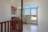 Hallway featuring light tile patterned flooring and a wealth of natural light