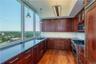 Kitchen featuring hardwood / wood-style flooring, decorative light fixtures, backsplash, and built in appliances