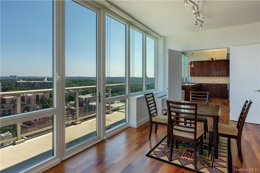 Dining room featuring rail lighting and dark hardwood / wood-style floors