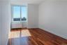 Spare room with radiator heating unit and dark hardwood / wood-style flooring