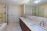 Full bathroom with shower with separate bathtub, tile patterned floors, double sink vanity, tile walls, and toilet
