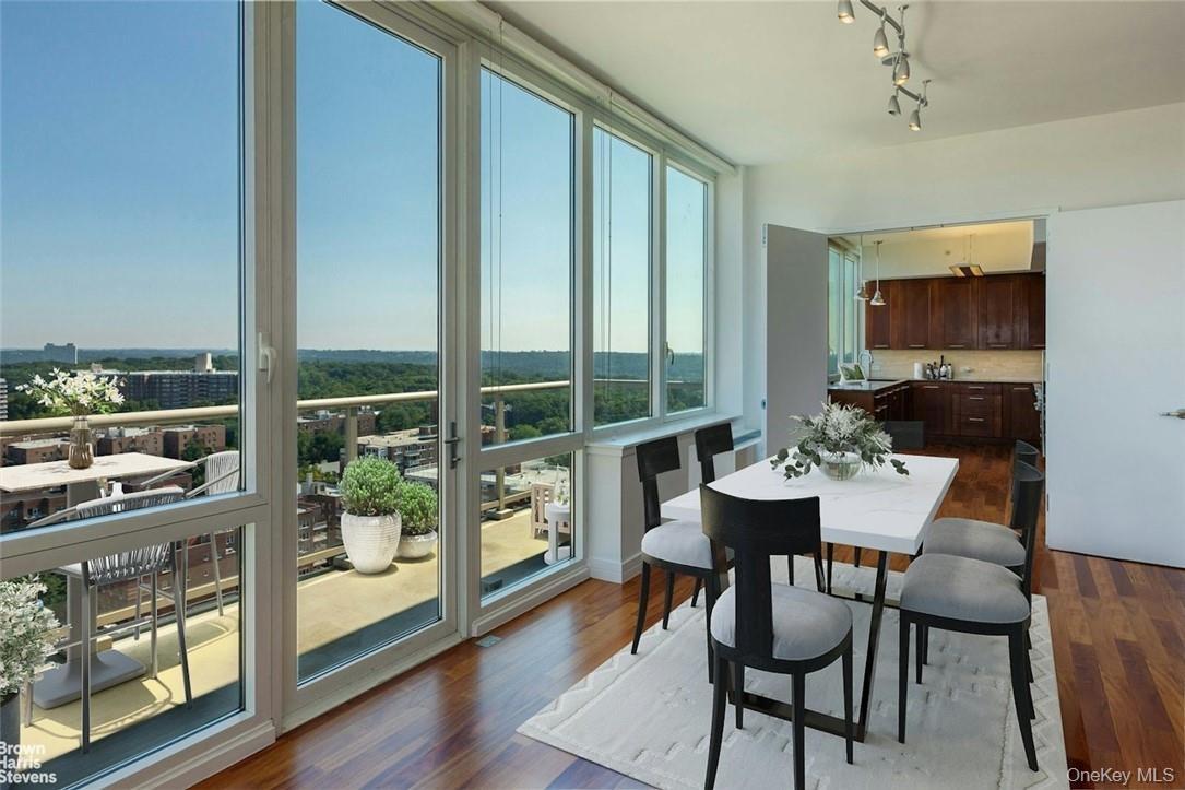 Dining space with rail lighting and hardwood / wood-style floors