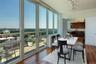 Dining space with rail lighting and hardwood / wood-style floors