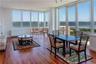 Sunroom / solarium featuring a water view and radiator