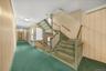 Stairway with carpet and baseboards