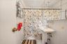 Bathroom with tile walls and shower / bath combination with curtain