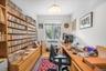 Home office with radiator heating unit and light wood finished floors