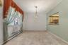Empty room with a baseboard heating unit, light tile patterned floors, and a textured ceiling