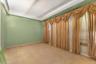 Tiled spare room with a textured ceiling and a tray ceiling