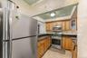 Kitchen with tile walls, light tile patterned floors, and stainless steel appliances