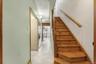 Stairs with tile patterned floors and a textured ceiling