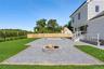 Fenced backyard featuring a patio and a fire pit