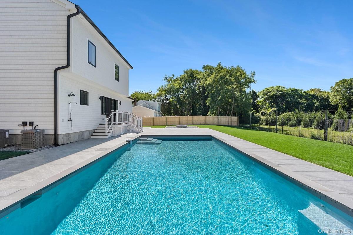 View of pool with a patio and a fenced backyard