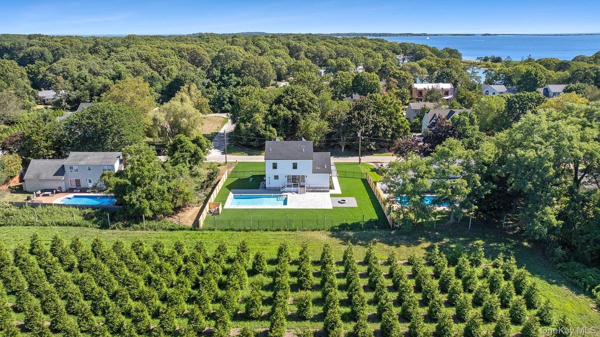 Aerial view of property and surrounding area featuring a pool