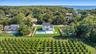Aerial view of property and surrounding area featuring a pool