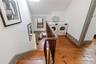 Stairway with washing machine and clothes dryer, wood-type flooring, and lofted ceiling