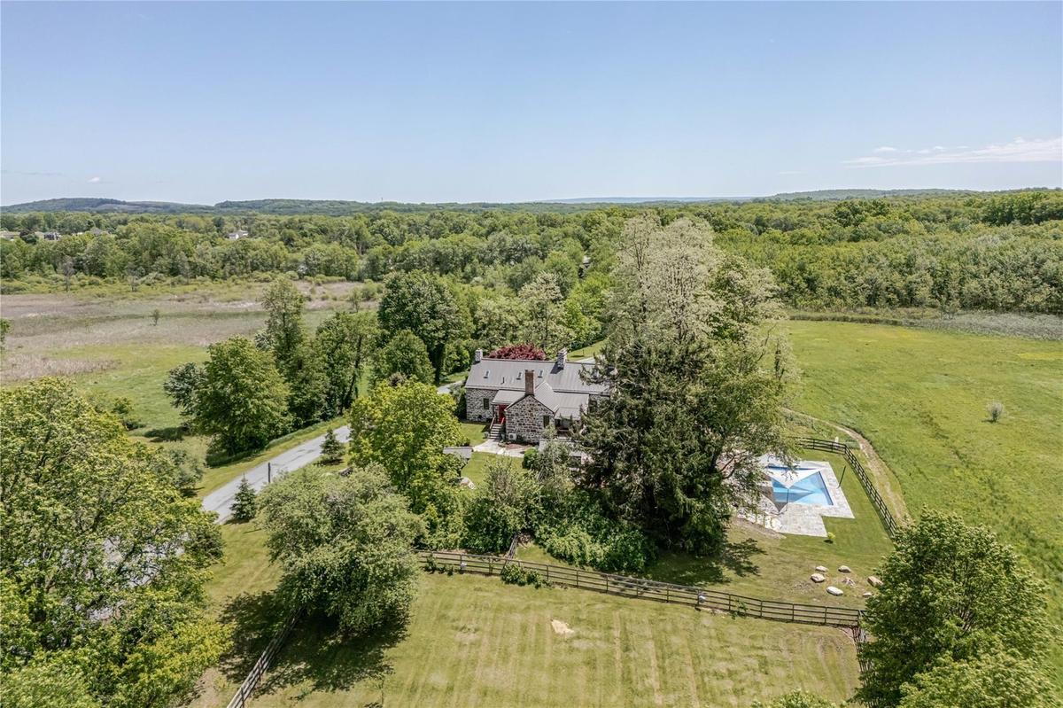 View of property location featuring a heavily wooded area and rural landscape