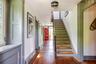 Stairs with hardwood / wood-style floors and baseboards