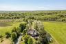 Aerial view of property and surrounding area featuring a heavily wooded area