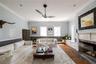 Living area featuring dark wood-style flooring, a ceiling fan, ornamental molding, a fireplace with flush hearth, and a baseboard heating unit