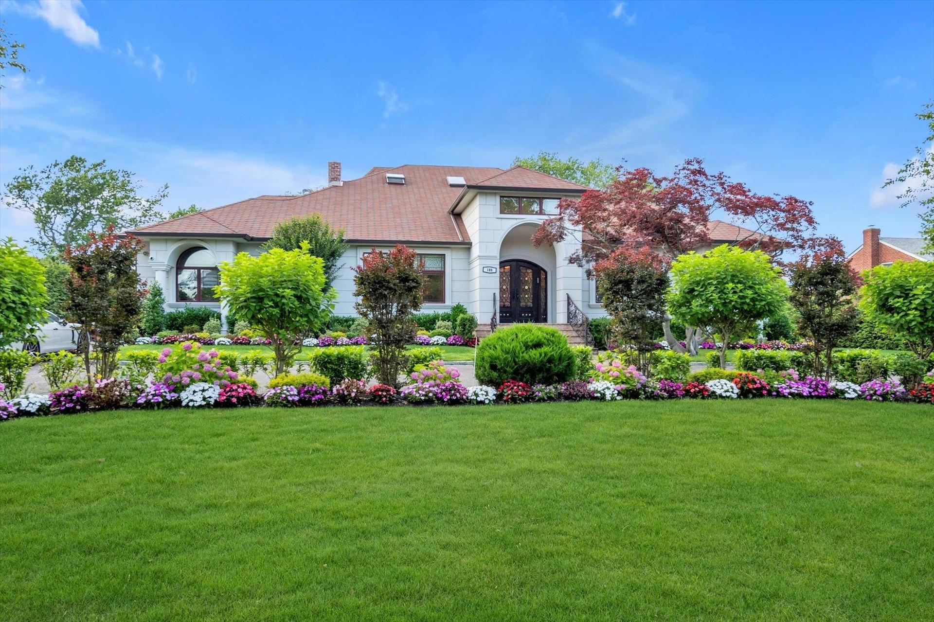 View of front of property with french doors, a chimney, and a front lawn