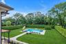 View of pool with view of Privacy trees